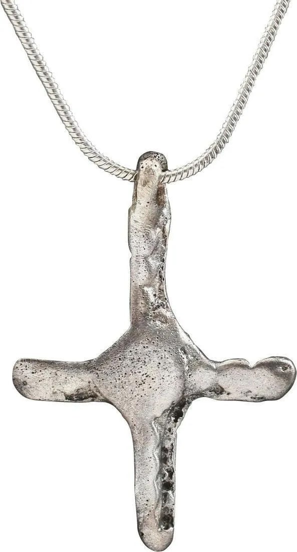 EUROPEAN CROSS NECKLACE, 12TH-14TH CENTURY: Silvered bronze, about 1 1/8" height plus the suspension loop. The crossbeam centered and the beam ends ribbed, degenerated from the Jerusalem Cross. As Christian faith evolved through its history, th