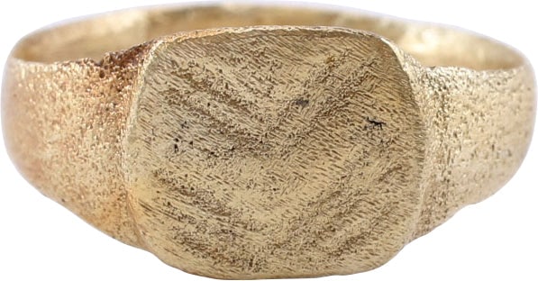 MEDIEVAL ENGLISH MAN’S RING C. 12th-15th CENTURY AD, 4 1/2: Gilt bronze, size 4 1/2 for the small finger as was the custom. with 2.3mm rounded face band flaring to the shoulders. Raised oval bezel with triple cut forming a chevron. Probably serving as a signet