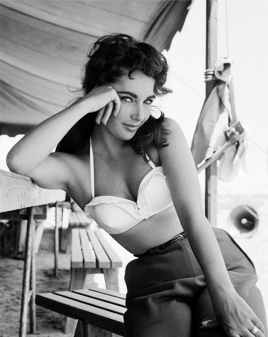 Elizabeth Taylor On The Set Of Giant - Oversize Limited Print: 1955 (Printed Later): Title: Elizabeth Taylor On The Set Of Giant - Oversize Limited Print: 1955 (Printed Later) Description: Elizabeth Taylor with Sunglasses for "Giant" 1955 by Frank Worth This iconic and elegant portrai