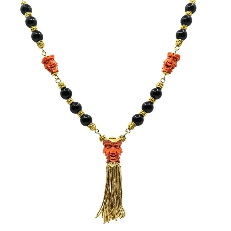 Vintage 18k Gold Carved Coral Devil Mask Onyx Tassel Necklace: Title: Vintage 18k Gold Carved Coral Devil Mask Onyx Tassel Necklace Description: Product details: CRCA: 1970’s MATERALS: 18k Yellow old EMSTONE: Coral, Onyx WEHT: 132.5 rams MEASREMENTS: 32R