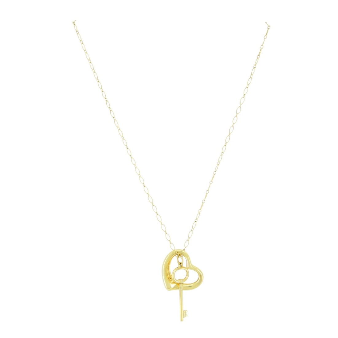 Tiffany & Co. Elsa Peretti Open Heart Key Pendant Necklace: Title: Tiffany & Co. Elsa Peretti Open Heart Key Pendant Necklace Description: This timeless Tiffany & Co. necklace features Elsa Peretti’s most iconic symbols. The sculptural Open Heart paired