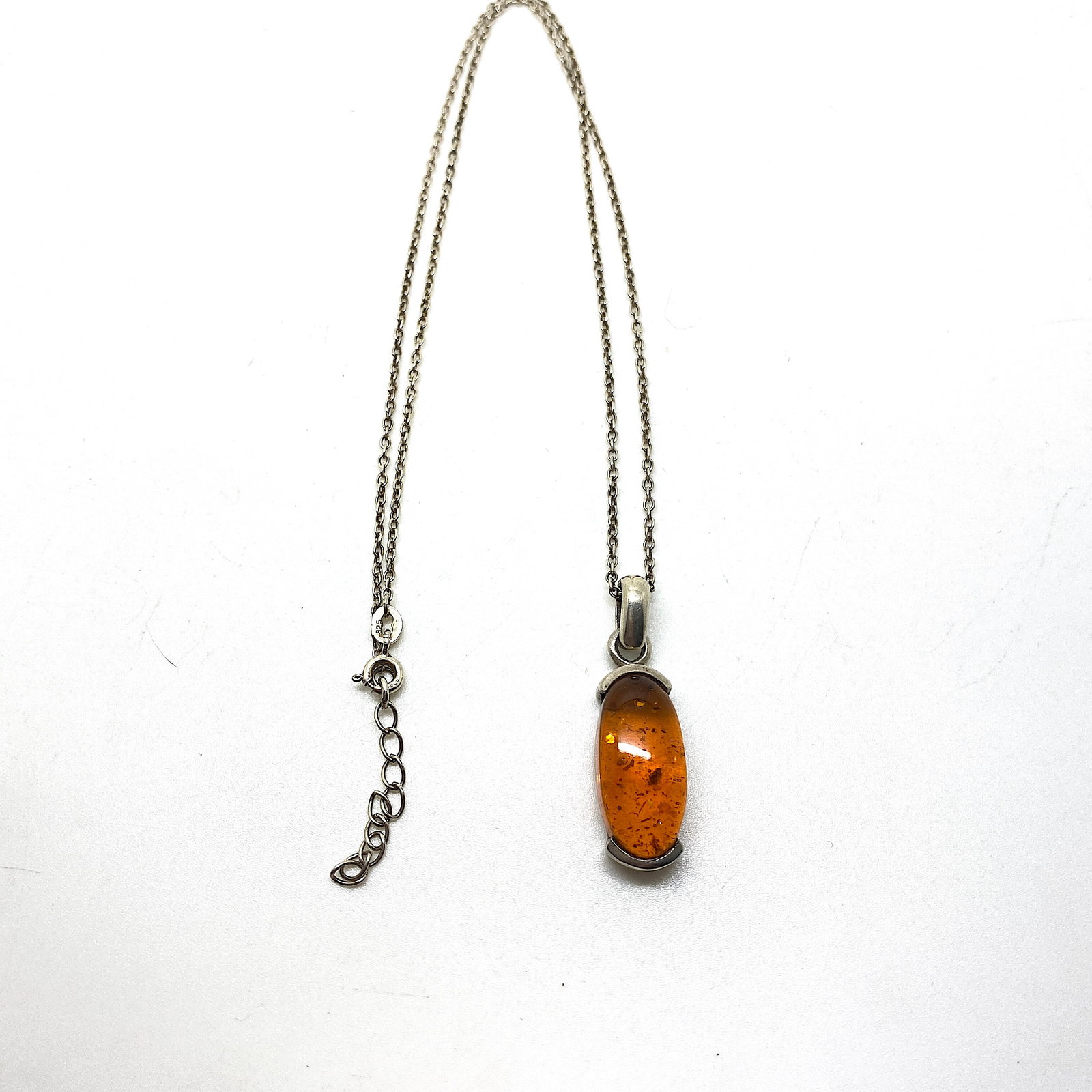 Remarkable Amber Pendant with chain, shaped like an Ornament: Title:Remarkable Amber Pendant with chain, shaped like an Ornament Metal:Sterling Silver Gemstone:Amber Weight:7.2 g Size:Size: 26.0 x 10.5 x 9.0 mm Size: 1.024 x 0.413 x 0.354 inches Made of:(Reconst