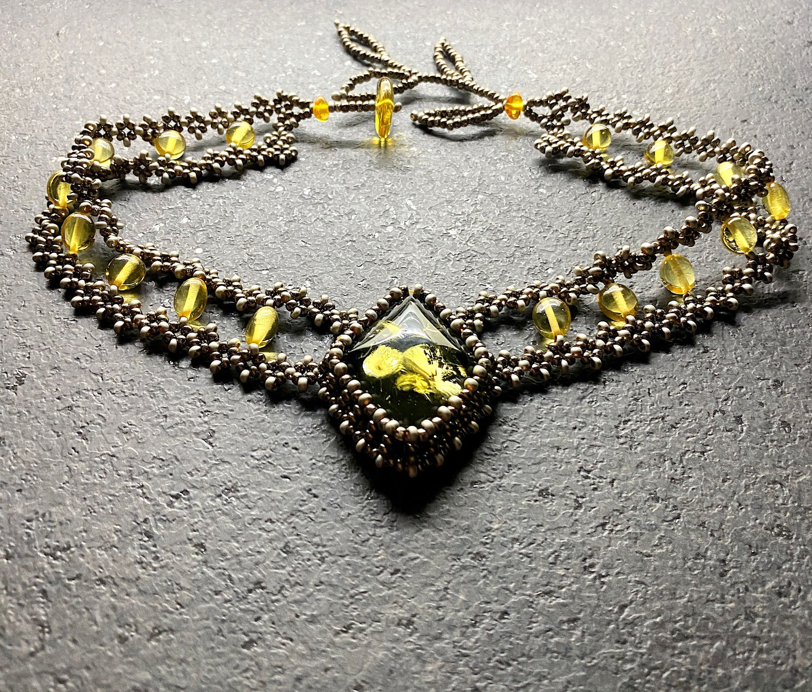 Antique Amber Floral Choker made from leaf like bead ornaments: Title:Antique Amber Floral Choker made from leaf like bead ornaments Metal:NoneGemstone:AmberWeight:19.3 gSize:Size: 380.0 x 10.0 x 30.0 mm Size: 14.961 x 0.394 x 1.181 inches Made of:(Reconstituted