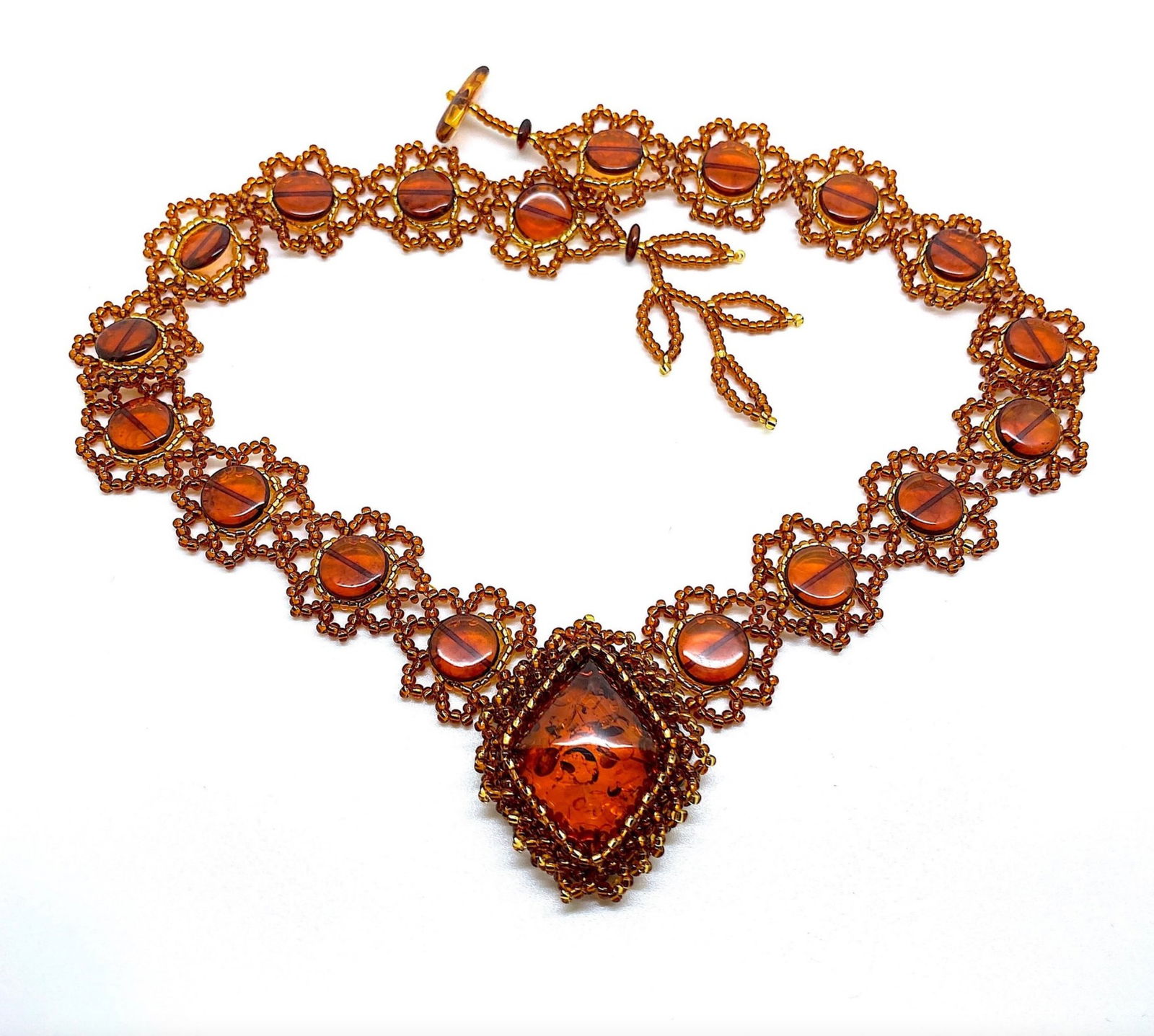 Fascinating Vintage Amber Floral Necklace made from leaf like bead ornaments: Title:Fascinating Vintage Amber Floral Necklace made from leaf like bead ornaments Metal:NoneGemstone:AmberWeight:28.5 gSize:Size: 520.0 x 42.0 x 10.0 mm Size: 20.472 x 1.654 x 0.394 inches Made