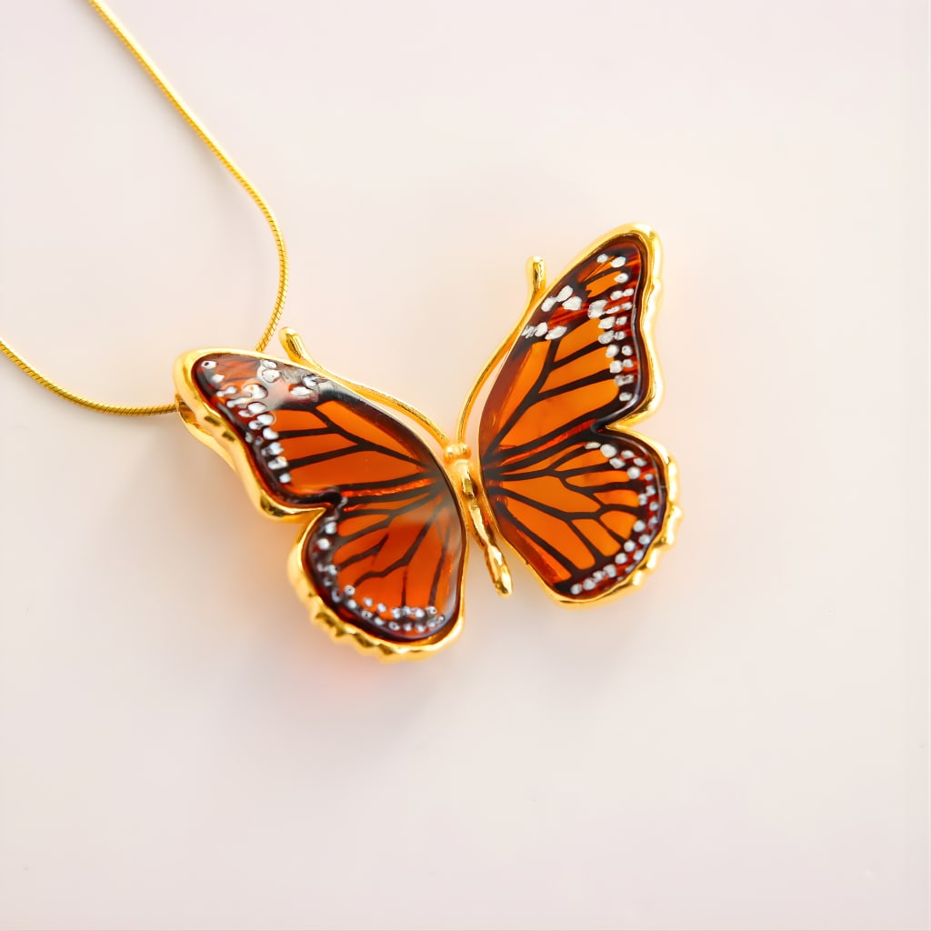 Baltic Amber Butterfly Necklace in 14k Gold Plated Silver: Title:Baltic Amber Butterfly Necklace in 14k Gold Plated SilverDescription:This butterfly necklace features laser-cut Baltic amber set in gold plated sterling silver. The warm amber panels highlight