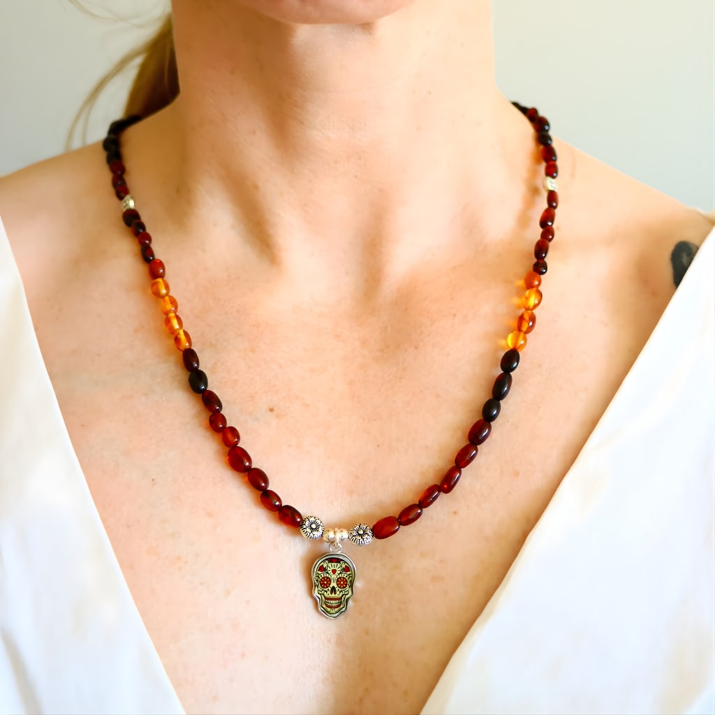 Day Of The Dead Baltic Amber Beaded Necklace: Title:Day Of The Dead Baltic Amber Beaded Necklace Description:This amber beaded necklace features genuine Baltic amber beads sourced from Lithuania and hand-assembled into a symbolic Day of the Dead
