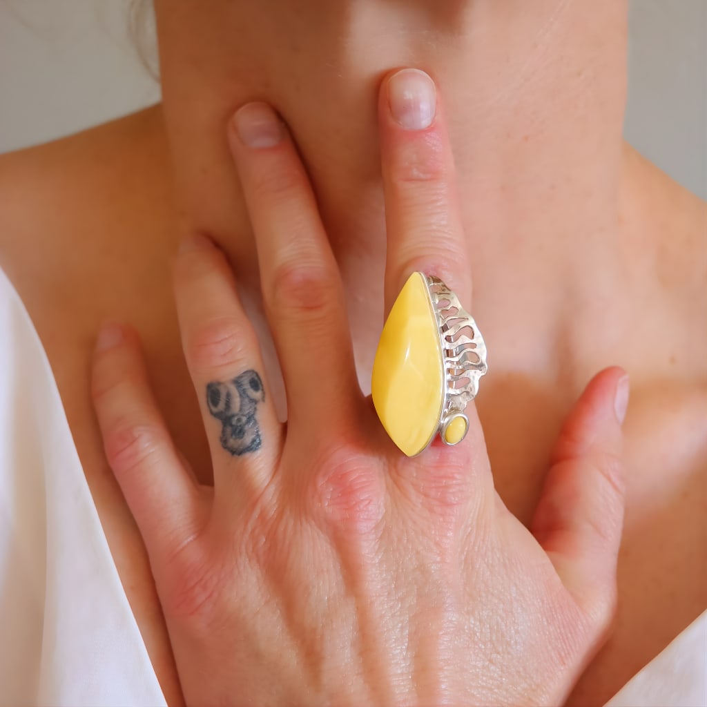 Handmade Butterscotch Amber Ring Sterling Silver: Title:Handmade Butterscotch Amber Ring Sterling SilverDescription:This handmade butterscotch amber ring features a bold abstract design crafted in sterling silver and made in Poland. The smooth,