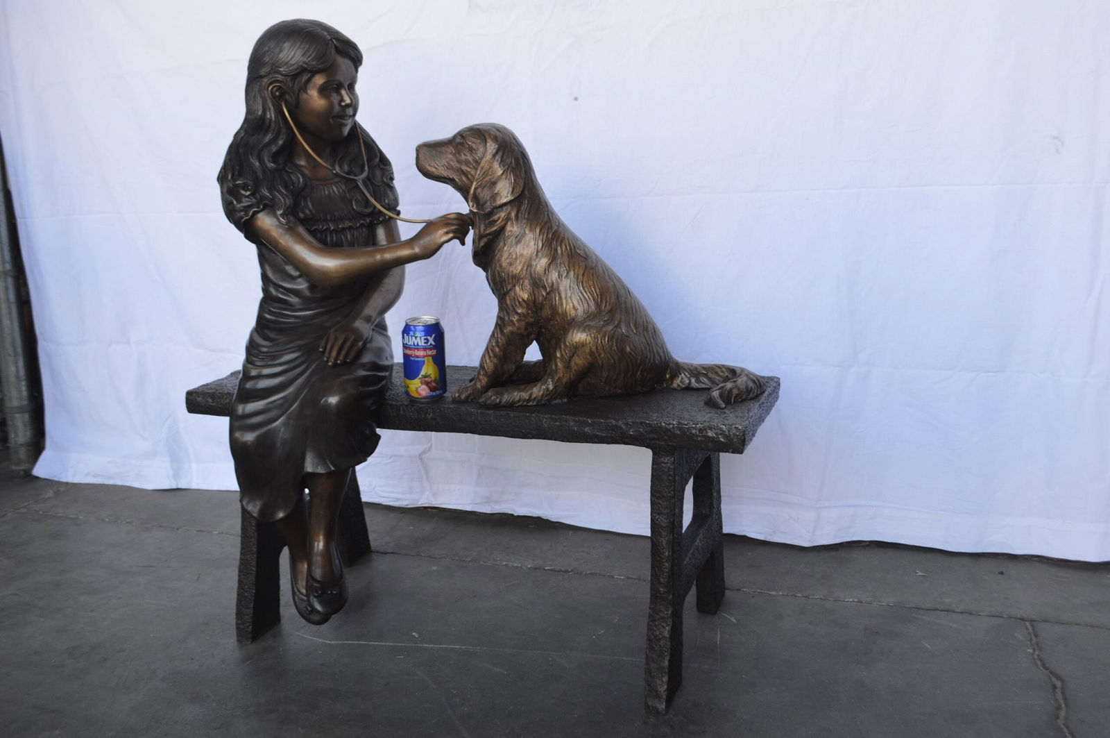 Girl plays Doctor on a Bench W Dog Bronze Statue - Size: 38"L x 18"W x 39"H. - 6
