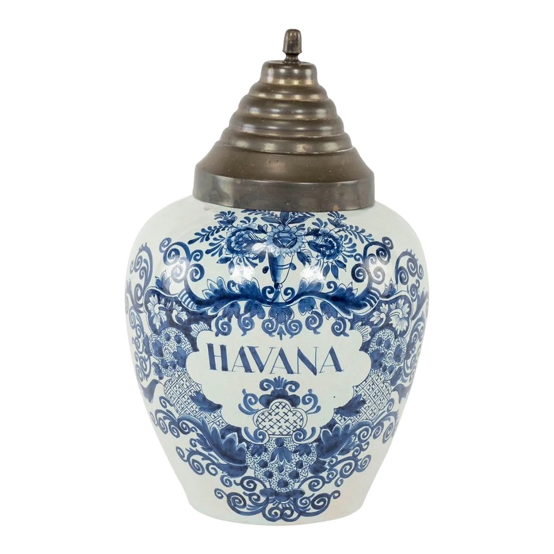 Delft Blue and White "Havana" Tobacco Jar: Delft blue and white "Havana" tobacco jar, with stepped brass lid. Made in the Netherlands circa 1800. Surface of jar decorated with floral cartouche, within which "Havana" is inscribed. De Drie Klokk