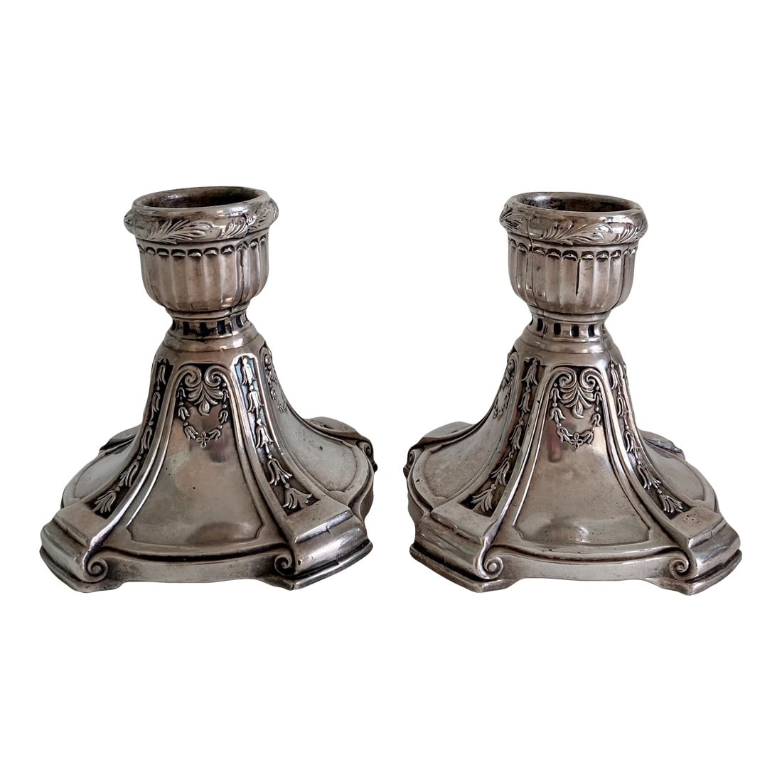 Circa 1900, Benedict Silver Plate Candlesticks, Set of 2, Edwardian Period, Floral Swag Scrollwork D: An exquisite pair of substantial Edwardian period, silver plate candlesticks by Benedict Manufacturing Company. Candlesticks feature a floral swag pattern on each side, along with a floral pattern bet