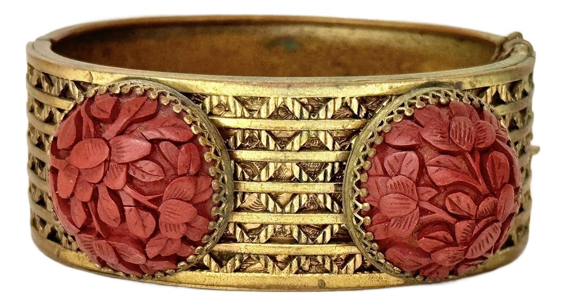 Antique Cinnabar and Brass Bracelet: Wonderful brass and cinnabar bracelet. Features intricate floral detailing on the cinnabar cabachons while the brass has an intricately detailed lattice design. Clasp closure. A timeless piece for eve