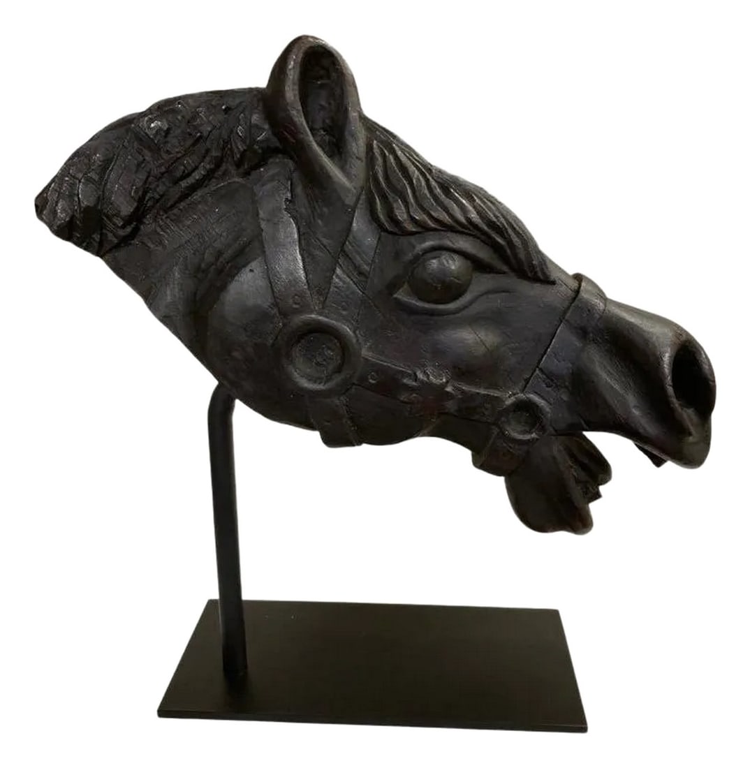 19th Century American Carved Wood Horse Head: Hand carved wood head of a horse, stained black, shown wearing a bridal and bit, with mouth open as if in a full gallop. A very handsome piece of sculpture, likely a fragment from a larger piece, now