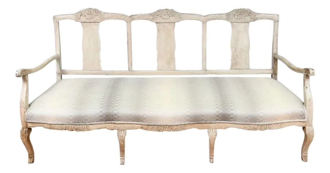 Late 18th-Early 19th Century French Carved Sofa: Long and low 18th-19th century French Settee. Gorgeous patina at usual wear points of the arms. Carved foliate & floral medallion crest rail, over three shaped back splats. Arms with scrolled knuckles