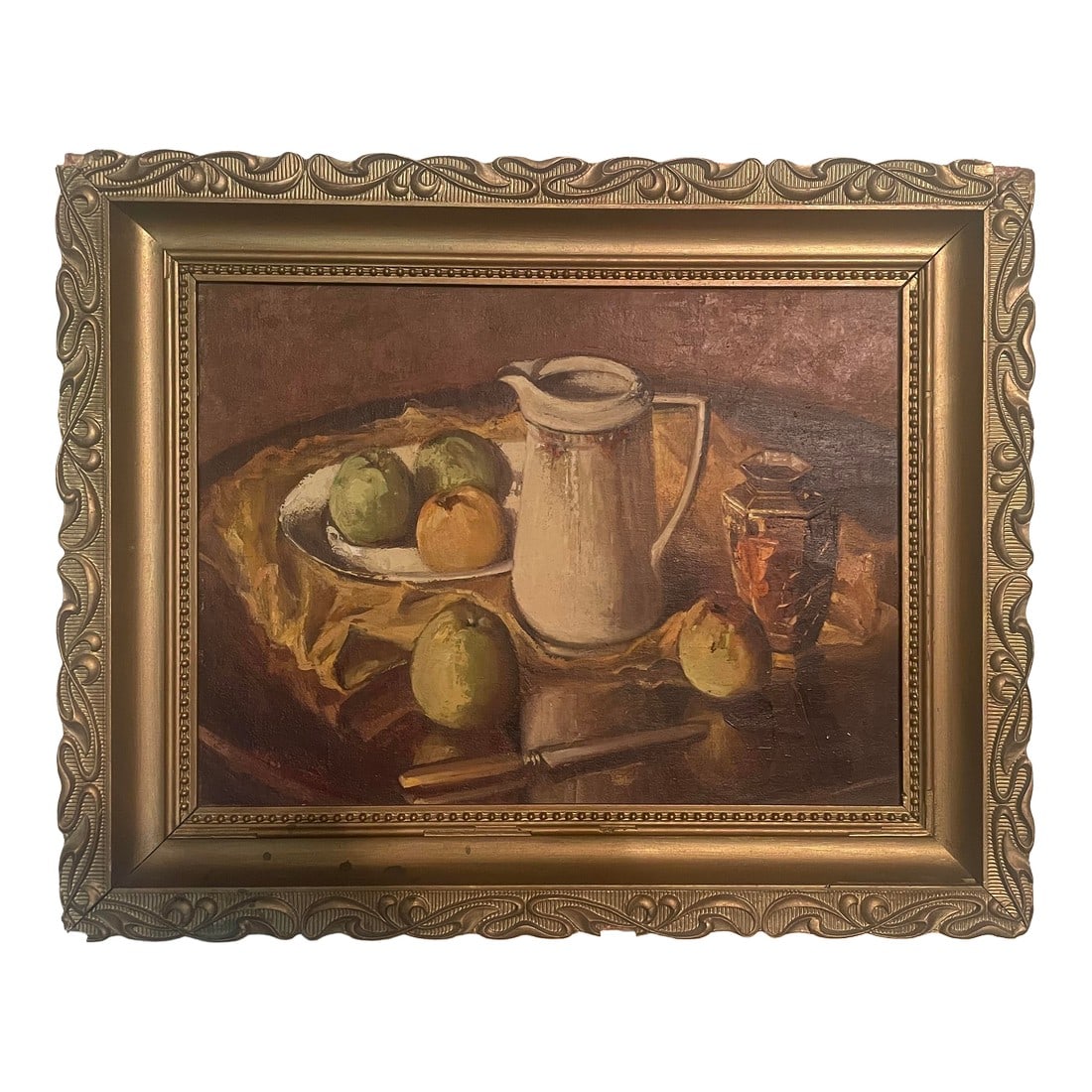 Antique European Oil Still Life Painting: Antique framed still life oil painting featuring a white pitcher, plate of apples, and a decorative jar on a draped yellow cloth background. Presented in an ornate, carved gold-tone wooden frame. The