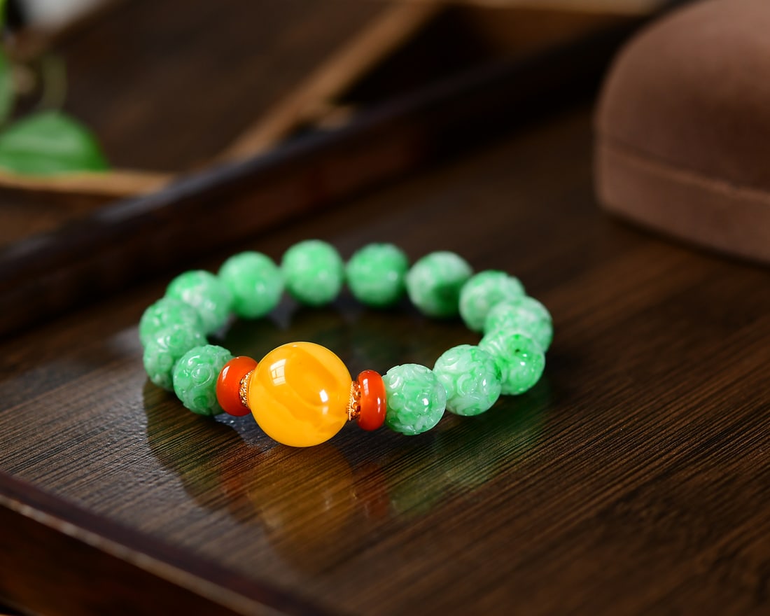 Chinese Green Jadeite Beads & Yellow Beeswax Hand Chain: Title: Chinese Green Jadeite Beads & Yellow Beeswax Hand Chain Origin: Chinese Date/Period: After2020 Materials: Jadeite Dimensions: 12.3-17(mm) 0.48-0.67(inches) Reserve: $1,566.00 