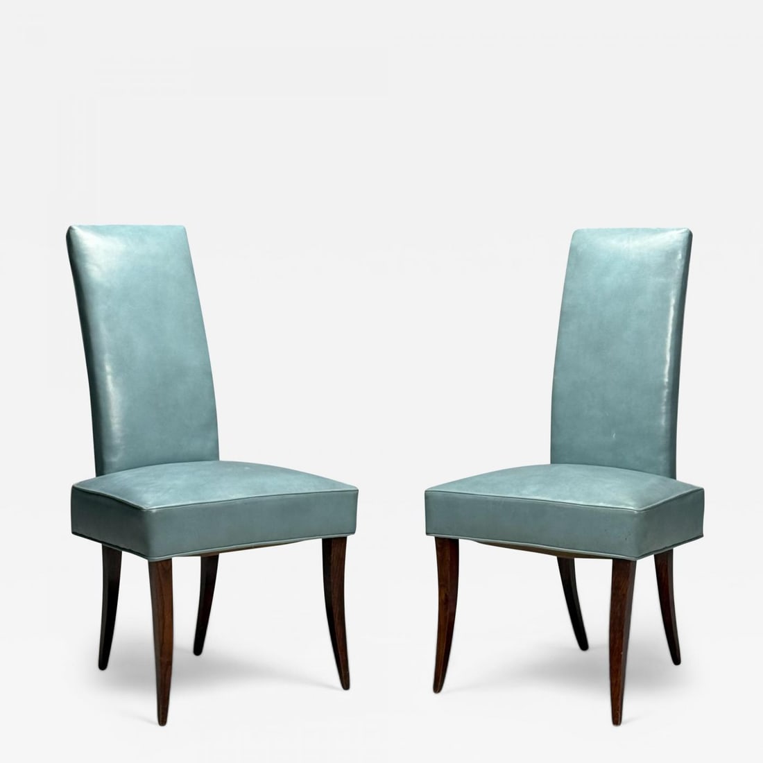 Dunbar, Mid-Century Modern, Occasional Chairs, Leather, Rosewood, 1950s: Dunbar, Mid-Century Modern, Occasional Chairs, Leather, Rosewood, 1950s This pair of occasional chairs produced by Dunbar in the mid-20th century, showcases a striking design with their leather-uphols