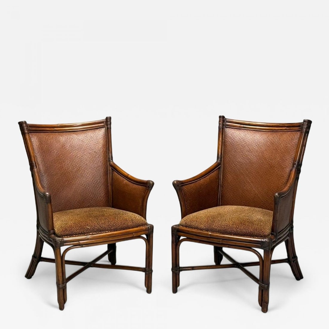 American Modern, Bamboo, Rattan, Arm Chairs, USA, 1970s: American Modern, Bamboo, Rattan, Arm Chairs, USA, 1970s Pair of American modernist armchairs having a woven rattan pattern on the arms and backrest and non-removable cheetah fabric seat cushions. Bamb