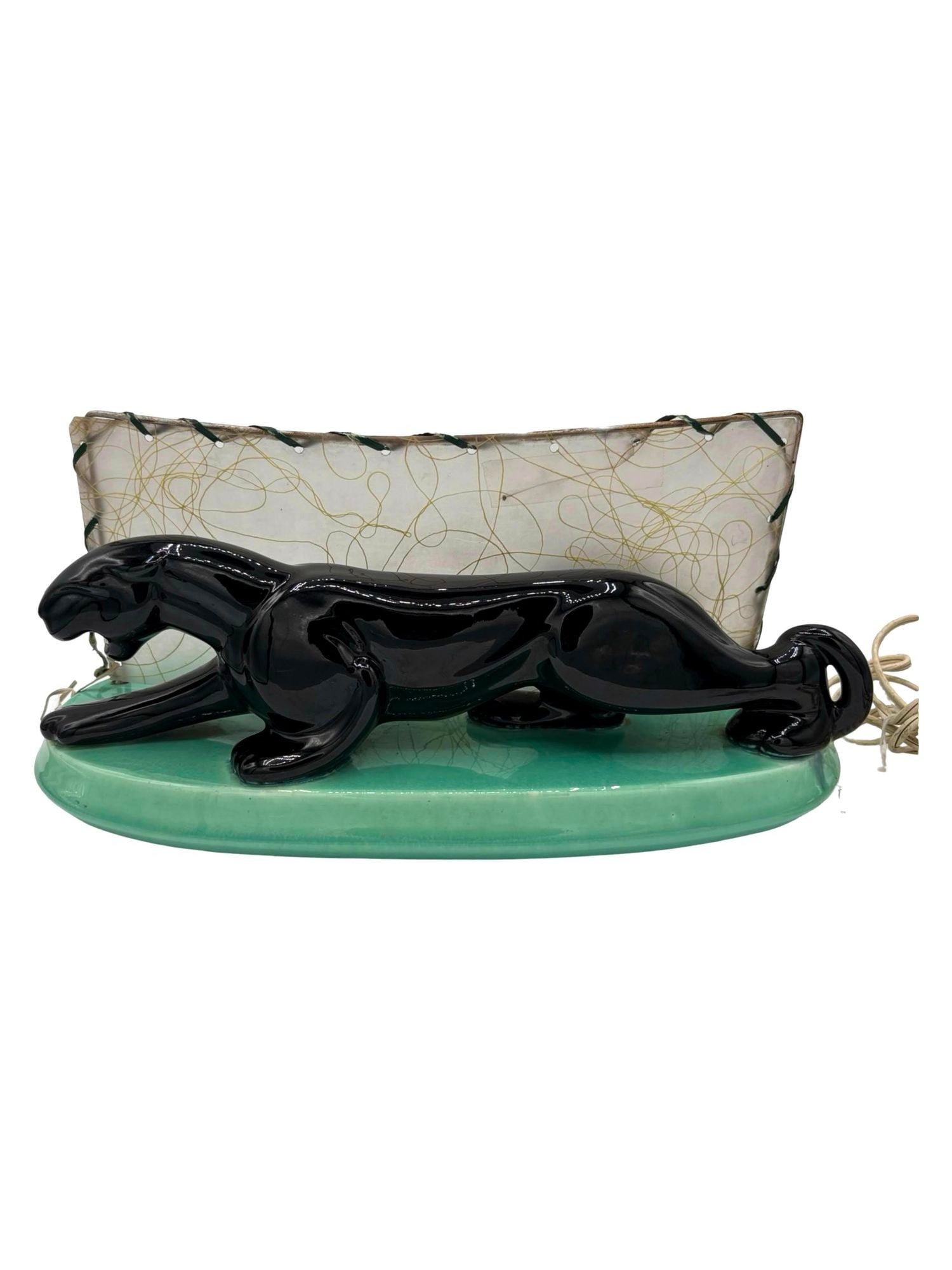 Midcentury Black Panther Ceramic Statue Lamp w/ Whipple Stitch Fiberglass Shade: Midcentury panther art pottery ceramic statue lamp featuring a high glazed black finish and detailed form of a panther ready to strike with a backlit Whipple stitch fiberglass shade. This piece is 13
