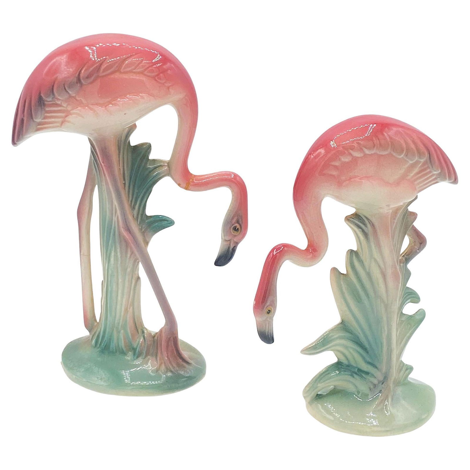 Mid-century Pink Drinking Flamingo Ceramic Tabletop Sculpture Set By Brad Keeler: Mid-century pink and green matching California ceramic flamingo tabletop statues by Brad Keeler. The set features two beautifully detailed pink flamingos bending down to take a drink in a lush green l
