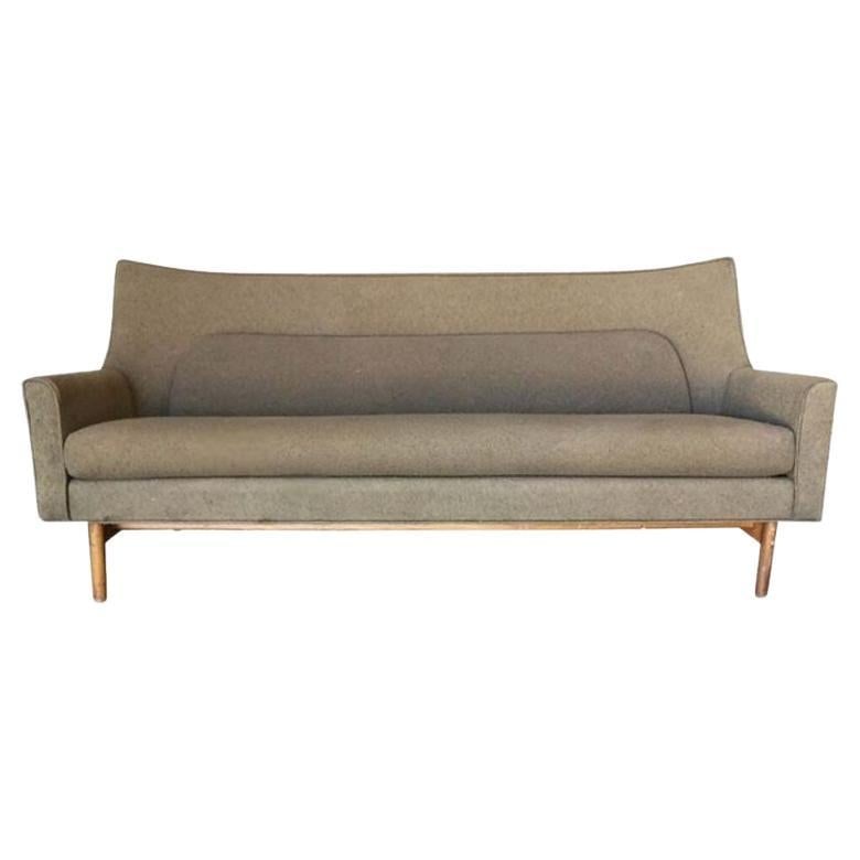 Paul McCobb "Pagoda" Style Arched Wing Sofa: Vintage Arched sofa fashioned after the iconic "Pagoda" by Paul McCobb with tapered legs, circa 1950, arched cathedral back, and low profile seat. This sofa has a clean look with a design nodding to t