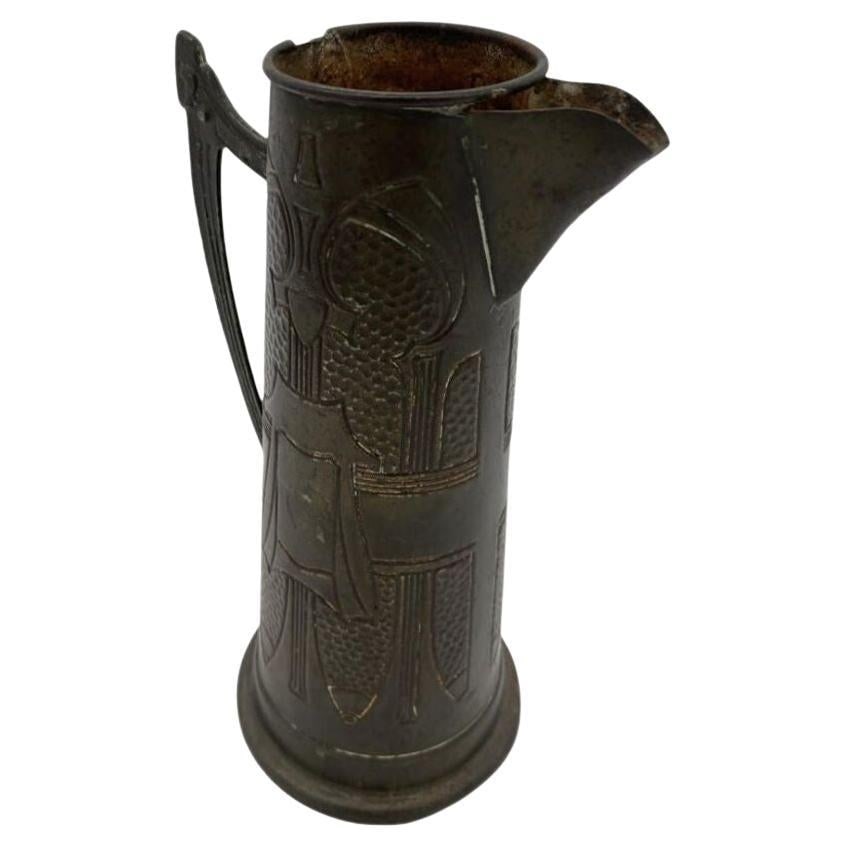 Late Victorian Austrian Bronze Art Nouveau Pitcher: Circa 1900 Jugendstil style/Art Nouveau, pewter pitcher featuring a scrolling design on on each side with an slightly geometric handle. Its slender design fits well in late Victorian settings.