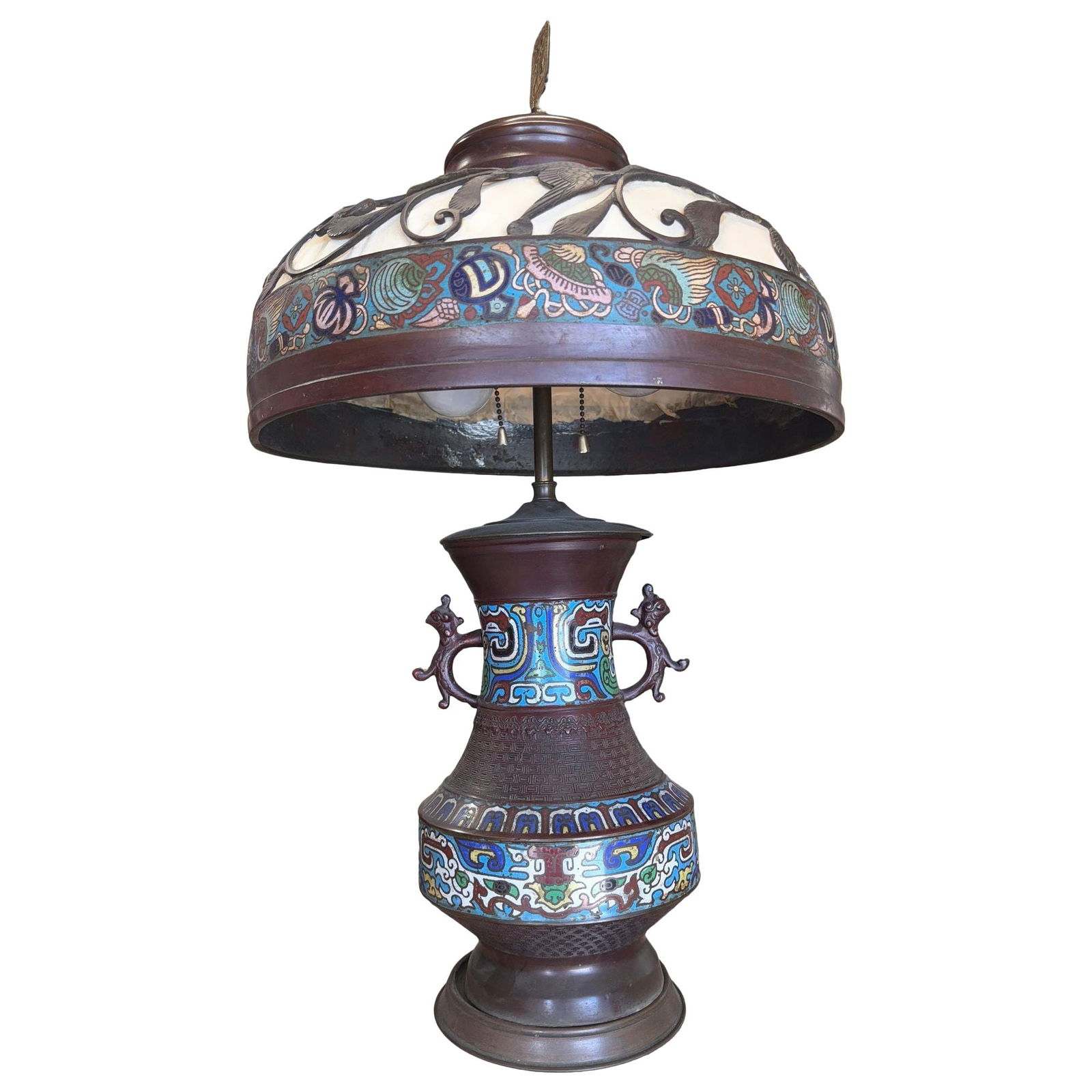 1910 Meiji Period Japanese Cloisonné Lamp with Wrought Iron and Enamel Shade: This 1910s Meiji Period table lamp features a Japanese cloisonné enamel vase base with vivid traditional motifs and dragon-form handles. Topped with a domed shade showcasing wrought iron scroll