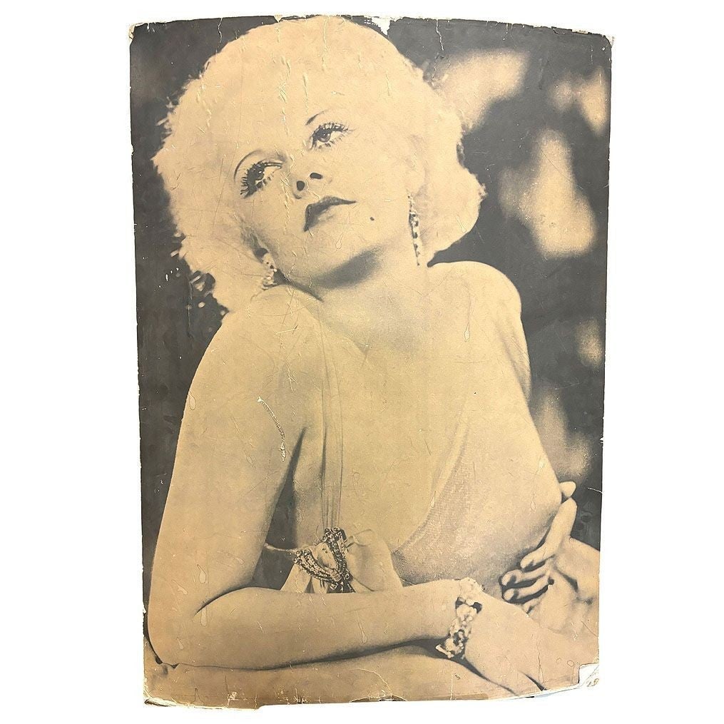 40" Tall Sepia Hollywood Starlett Photograph Jean Harlow Mounted to Pressboard: This glamorous 1950s matte poster-size photograph captures Hollywood icon Jean Harlow in an alluring yet tasteful pose. She gazes upward with a dreamy expression, her signature platinum blonde curls