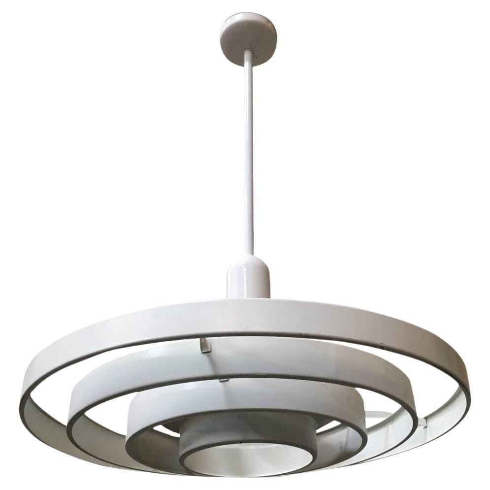 Mid-century "Saturn" Ceiling Steel 20" Pendant by Kurt Versen: Kurt Versen designed "Saturn" ceiling light featuring a stacked steel ring light shade suspended by wire to a focused light socket. Altogether this light fixture is 36" tall perfect for large vaulted