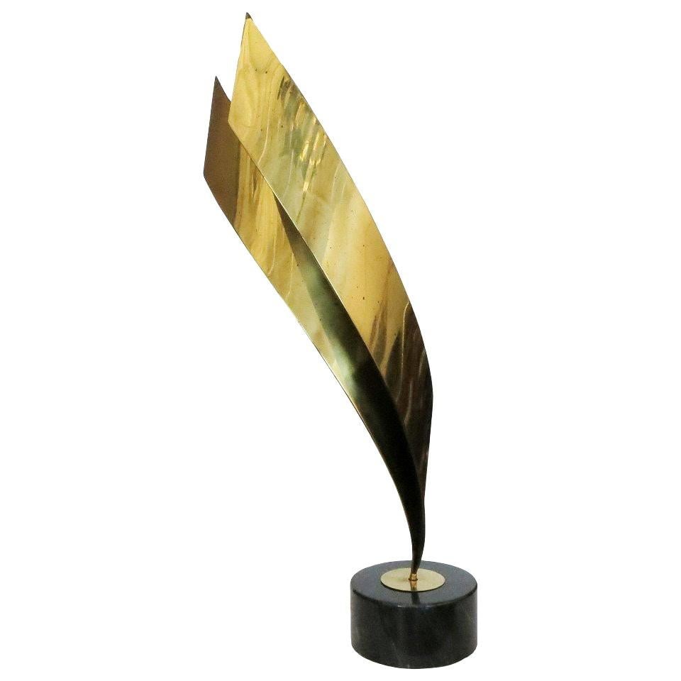 Post Modern Abstract Brass Table Sculpture by Curtis Jere, 1984: Tall brass abstract table sculpture on marble base by Curtis Jere, circa 1984. Vintage This large abstract metal sculpture, comprised of banded brass ribbons in a gold tone, and mounted on a mottled m