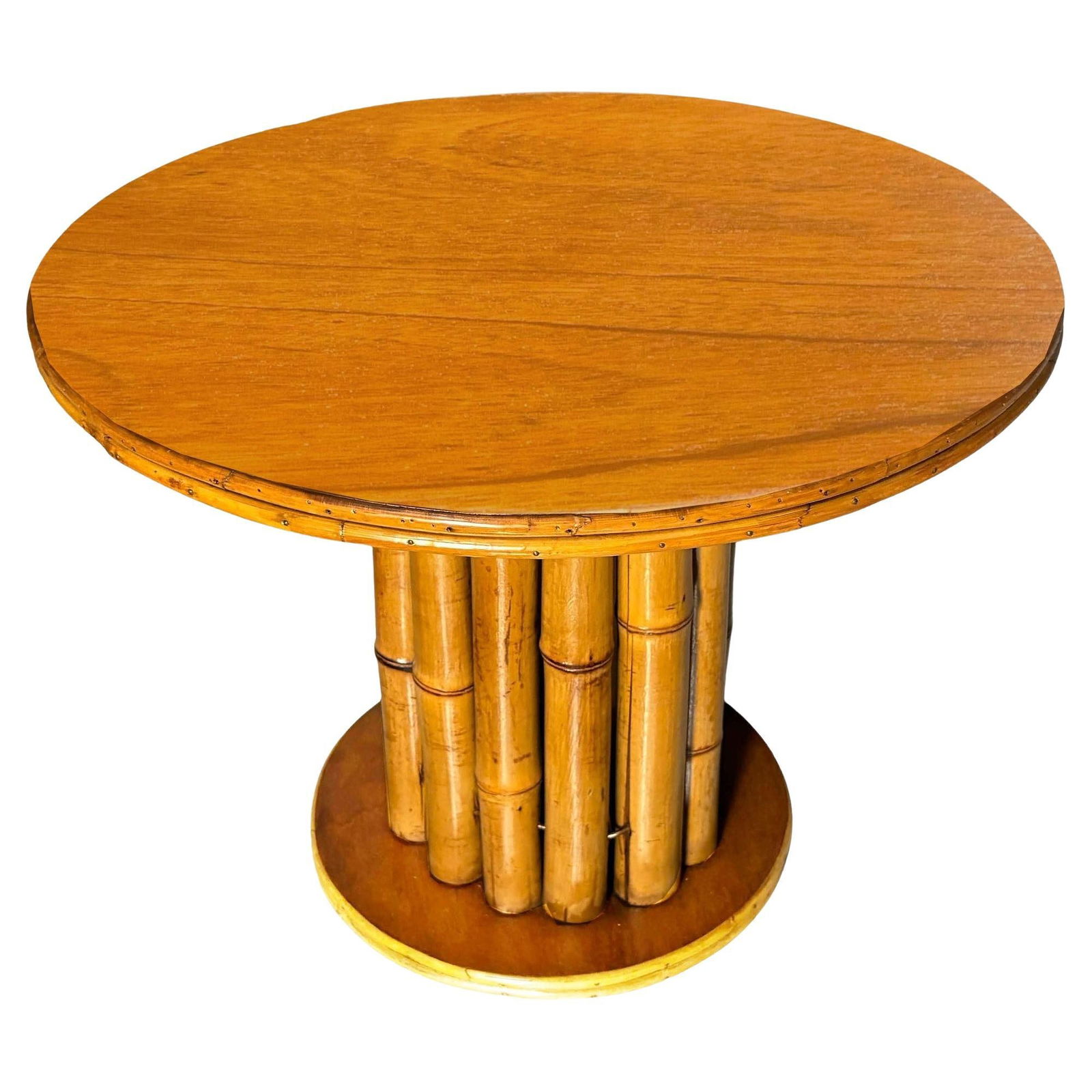Restored Rattan & Mahogany Round Pedestal Side Table: This restored rattan round pedestal end table boasts a charming vertically stacked rattan design featuring vertically stacked rattan poles sandwiched between a mahogany top and mahogany base. Its natu