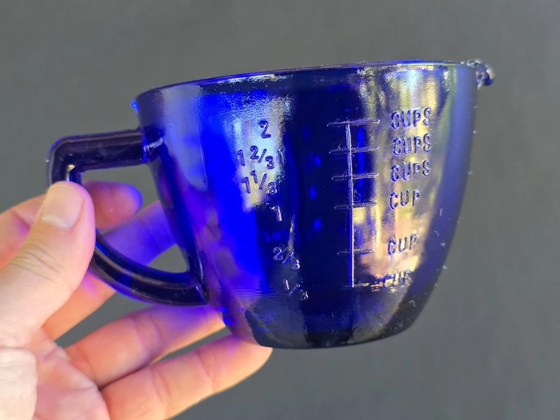 2 Cup Cobalt Blue Glass Measuring Cup: 5" Tall 2 cup measure Wonderful reproduction vibrant blue 2 cup measure. This set is must-have for any glassware collector. The item in the images is a model. Each item undergoes inspection before shi