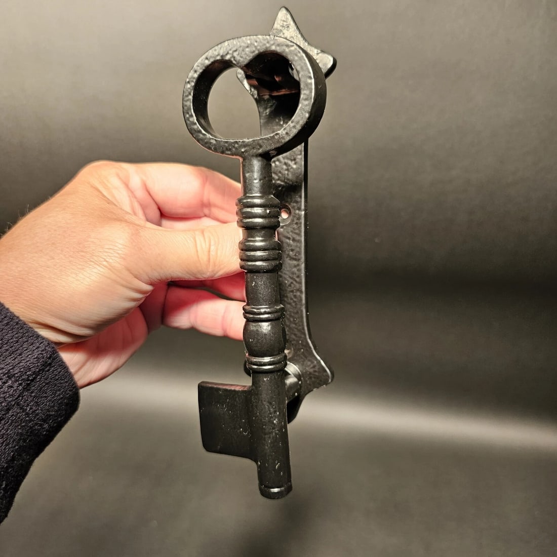 Black Cast Iron Key Door Knocker: 8" Long x 2" wide Nice heavy quality reproduction cast iron door knocker! As you can see this is a solid iron key door knocker. The key serves as the knocker. Wonderful sturdy baked on black finish.