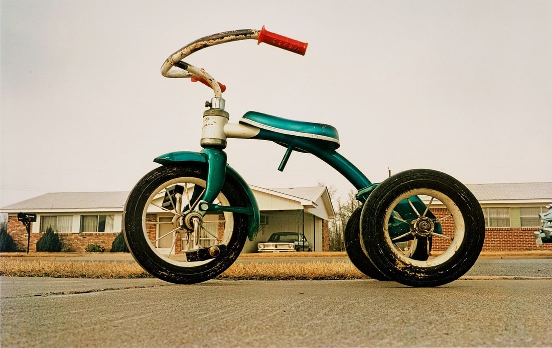 WILLIAM EGGLESTON TRICYCLE PHOTO PRINT: Title: WILLIAM EGGLESTON TRICYCLE PHOTO PRINT Description: William Eggleston Tricycle Photographic Print measuring at 20.5x30 inches Dimensions: 20.5x30" Reserve: $60.00 Shipping: Domestic: Flat-rate