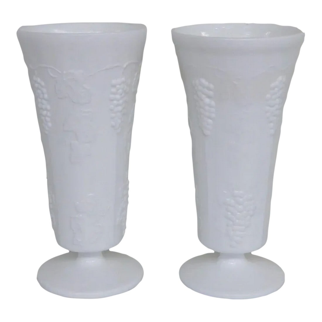 Westmoreland White Milk Glass Grapevine Design Footed Tall Vases a Pair: This beautiful pair of vases are made of milk glass. These vases are made in a gorgeous opaque white color, they both have a lovely footed silhouette with a stunning grapevine design decorating the