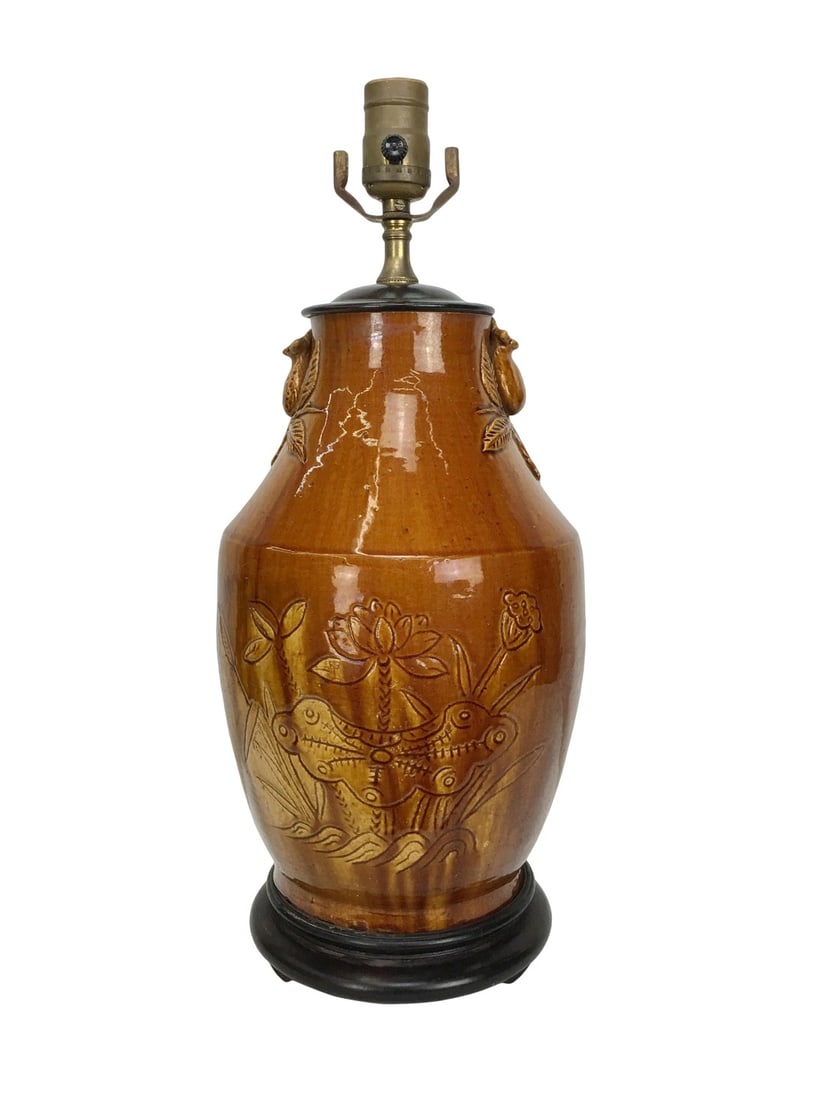 Vintage Ceramic Lotus Lamp: An Earthen glazed vintage Chinese style lotus lamp with glazed finish. This lamp features molded lotus flower handles on both sides of the lamp neck. On the body of the lamp are elegant lotus flowers