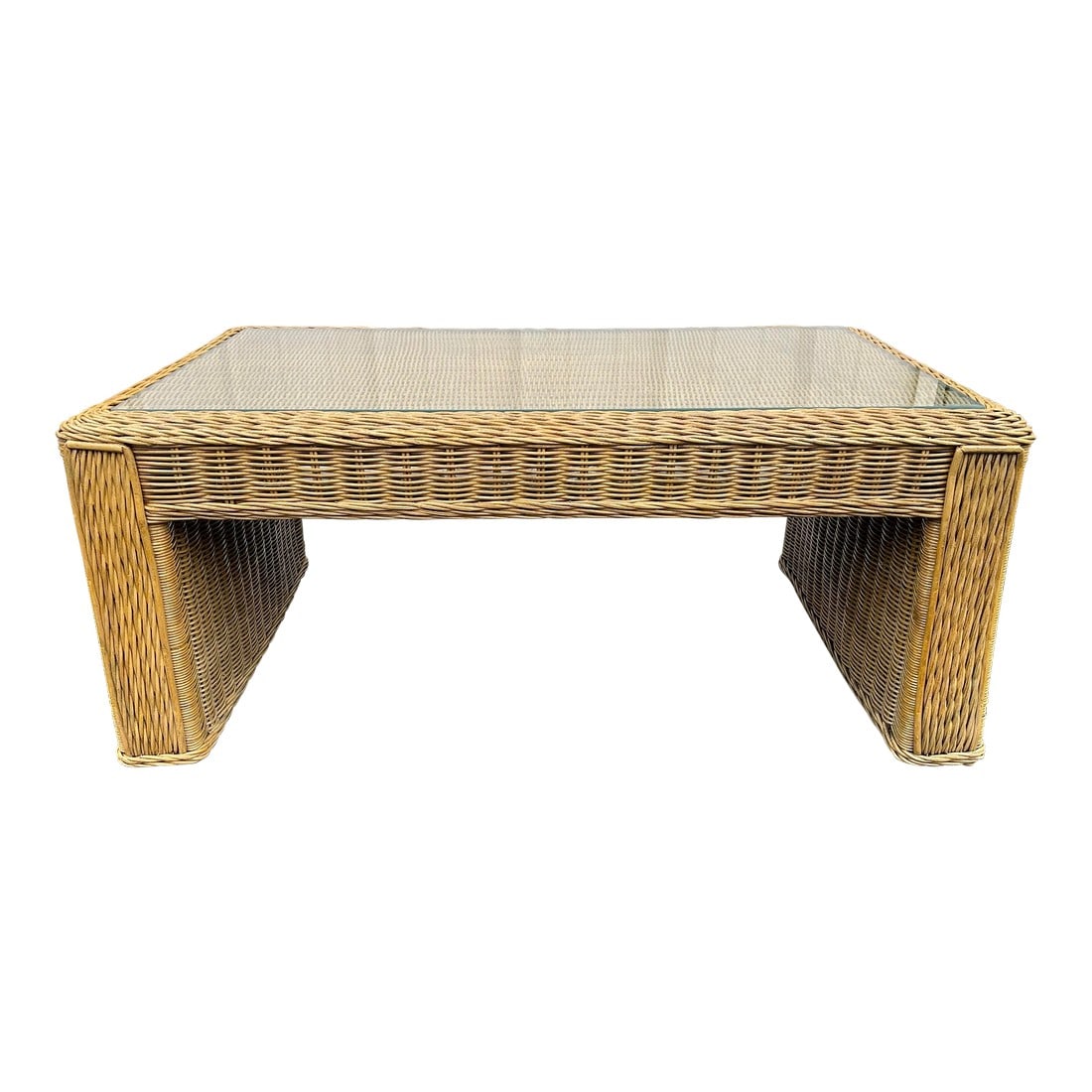 Vintage Coastal Woven Rattan Rectangular Coffee Table With Glass Top: Beautiful light caramel copper color and intricate weaving are the definitive highlights of this coastal style rattan coffee table. Modern thick bodied legs support this rattan table with a variety of