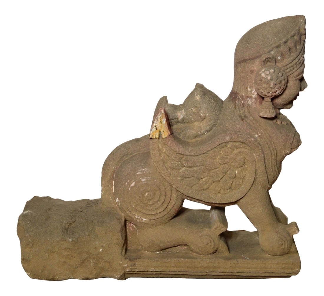 Indian Hand-Carved 19th Century Stone Sphinx Sculpture with Tiara and Earrings: A 19th century Indian sphinx hand-carved stone sculpture, probably intended to adorn and protect a temple. The Indian stone sculpture features a sphinx figure, showcasing a winged lion body and a woma