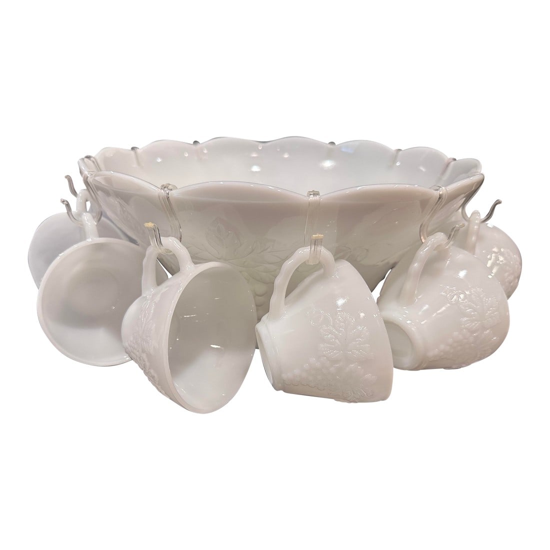 1960s Anchor Hocking Grape Vine Milk Glass Punch Bowl Set- 12 Pieces: 1960s Anchor Hocking milk glass punch bowl set comes with 11 (now 12) matching cups, and hangers for the cups. The bowl and cups are embossed with the Harvest pattern-a grape leaf vine design. 