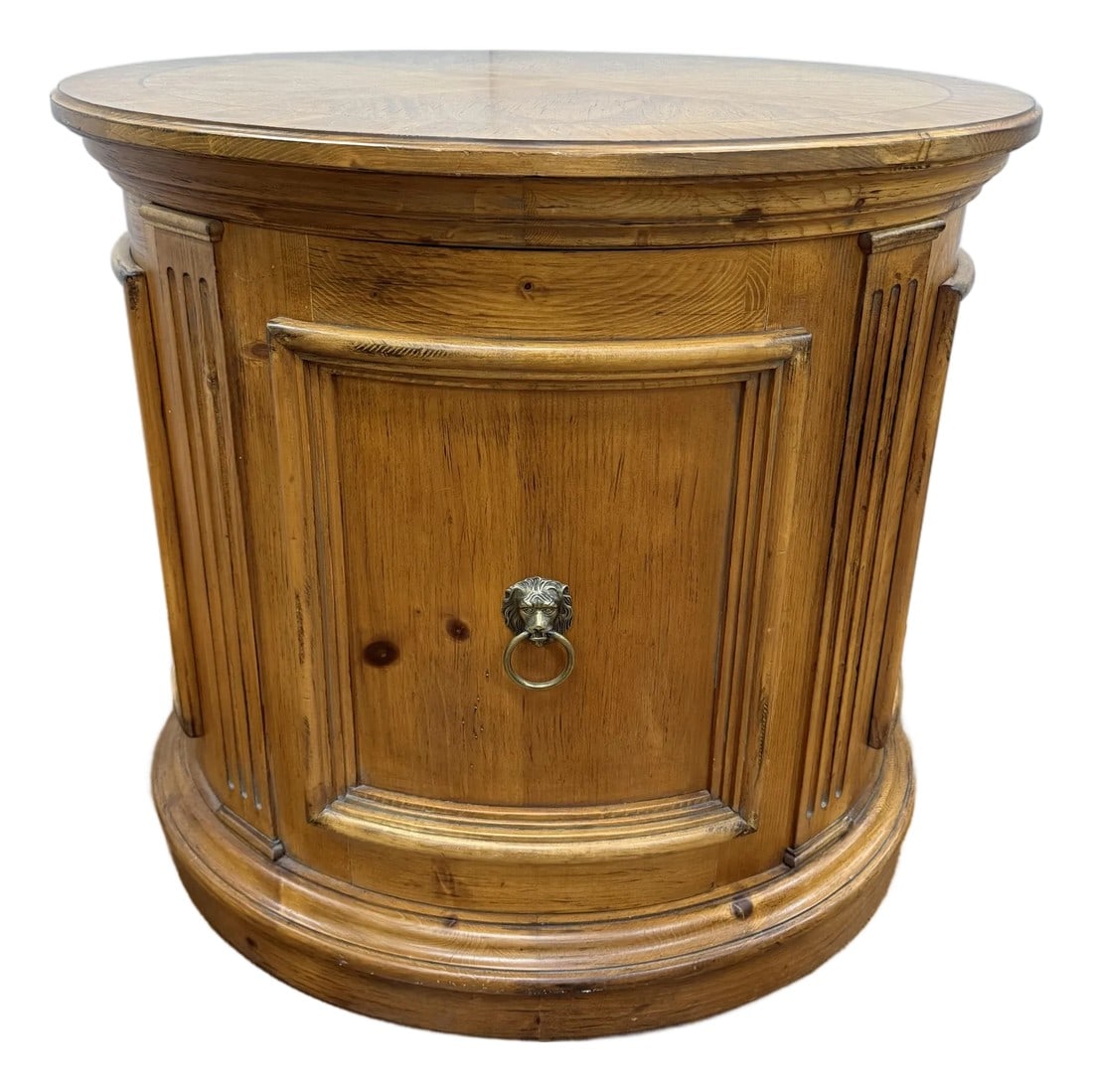 Ethan Allen Tuscan Oval Cabinet Drum Table: Ethan Allen Tuscany oval drum table has one door and three faux doors with lion head pulls and one adjustable shelf. Richly finished in a warm vintage pine. Slight distressing adds time-worn appeal. C