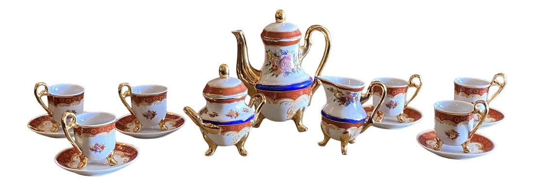 1960s Floral Tea Set, 17 Pieces: Stunning 17 piece set Tea Set. Includes Teapot with Lid , Creamer , Sugar Bowl With Lid along with Six Cups and Six Saucers in a stunning pattern of colors including white , gold , cinnamon, blue and