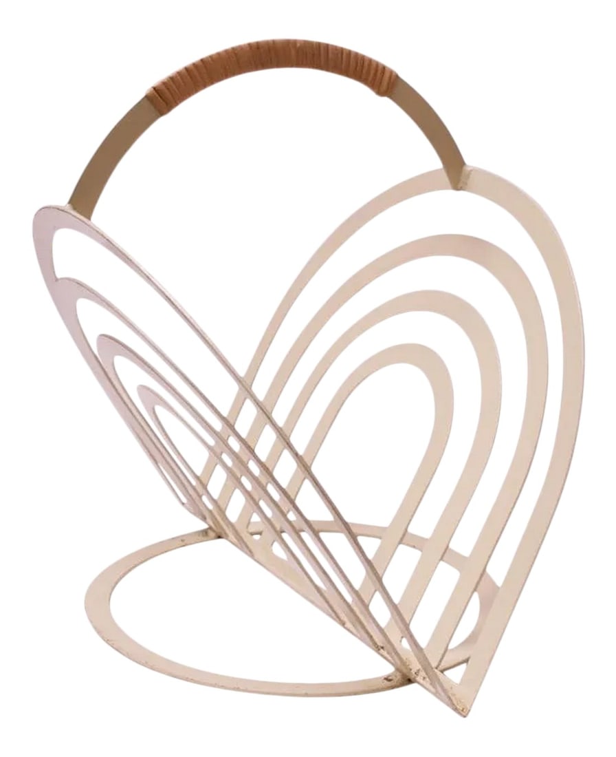 Designer Vintage "Arched" Magazine Rack after Vernor Panton: Magazine rack in off-white painted metal with a cane-wrapped handle, circa 1970s. Features two splayed 'arches' supported by a round base. Very unique form, reminiscent of designs by Vernor Panton,
