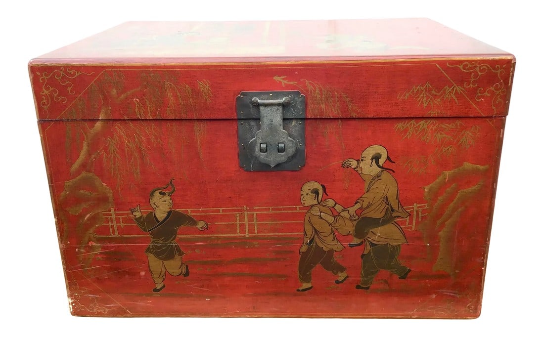 Red Lacquer Chinoiserie Trunk - Box: Asian style trunk with two side handles and center latch. Painted in a red lacquered chinoiserie finish with gold gilt motifs. Its painted top opens to ample storage space. Condition: Alterations: Ori