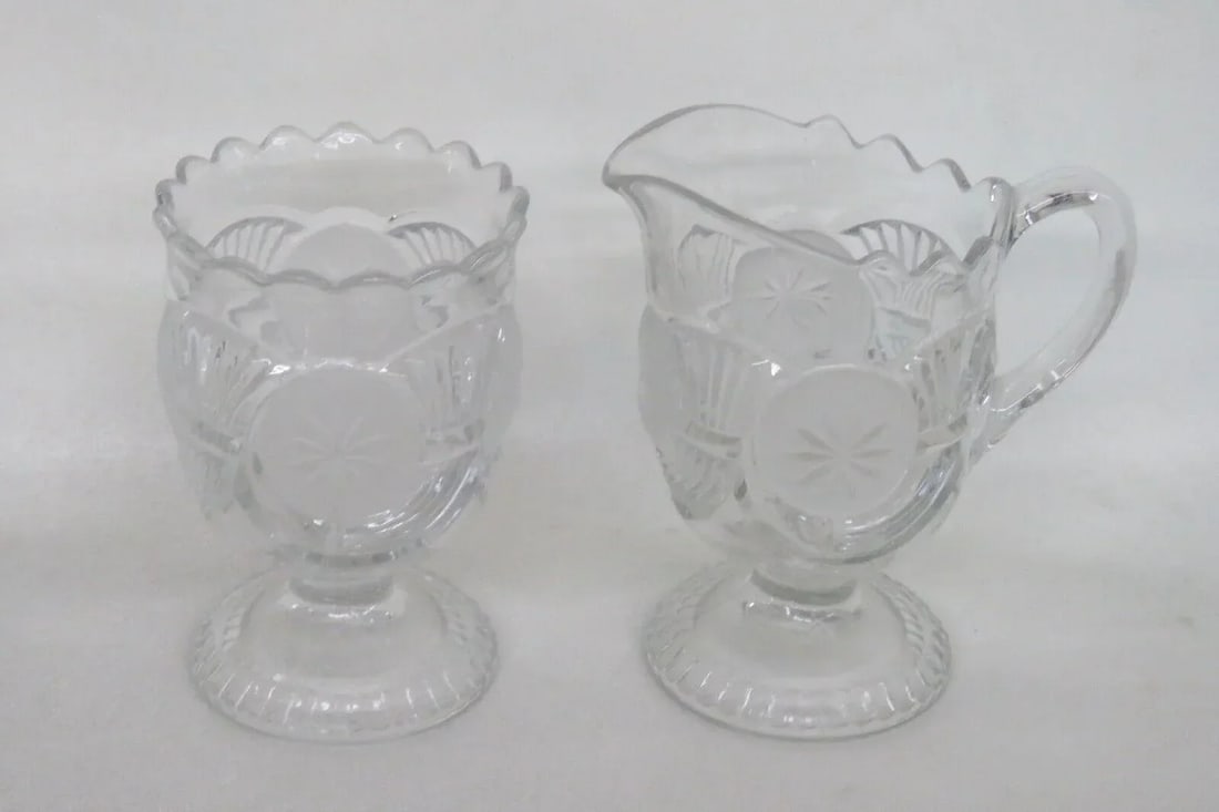 Eapg Glass Horn of Plenty Frosted Circle Footed Creamer and Sugar Bowl Set: This wonderful Set of a footed Creamer and Sugar Bowl is made of glass. This Set appears to be Early American Pattern Glass (EAPG) pieces, both pieces are made in a gorgeous clear color and are made