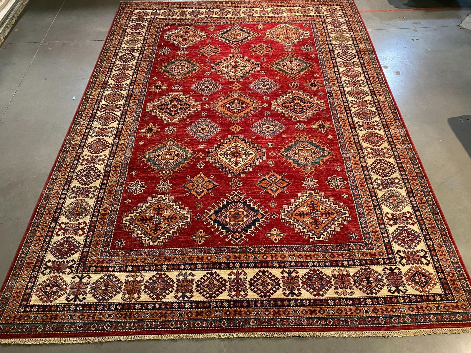 EXQUISITE FINE SUPER KAZAK RUG 8'.2"x11'.2": Title:EXQUISITE FINE SUPER KAZAK RUG 8'.2"x11'.2" Description:8'.2"x11'.2" Super quality Unique design Kazak Rug, hand spun and hand knotted rug in Pakistan 100% Vegge Dye natural wool with luxurious