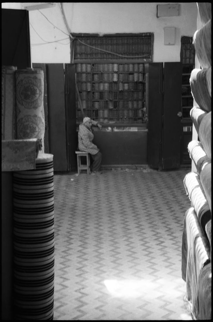 Cloth Merchant, The Medina, Fes, Morocco - Silver Gelatin: Title: Cloth Merchant, The Medina, Fes, Morocco - Silver Gelatin Description: Title: Cloth Merchant, The Medina, Fes, Morocco - Silver Gelatin Photograph - Limited Edition of 10Artist: Paul