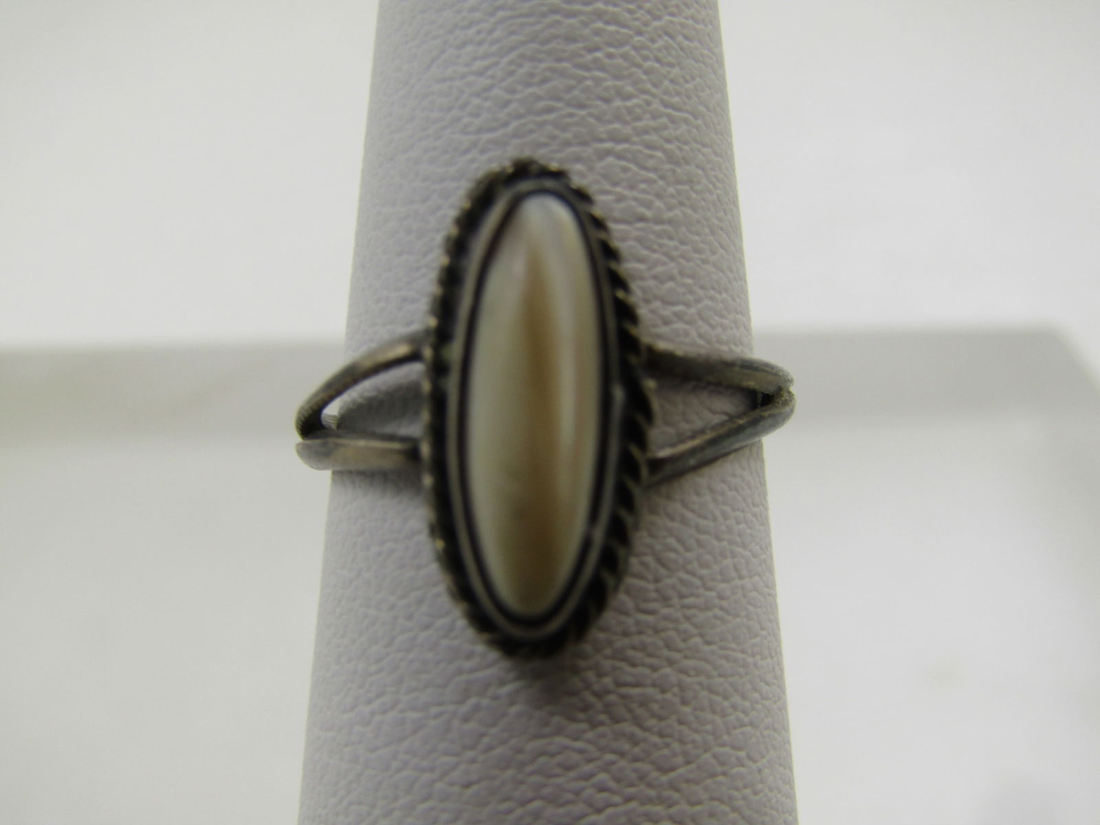 Vintage Sterling Southwestern Mother-of-Pearl Ring, Size 6, 1960's-1970's: Vintage Sterling Southwestern Mother-of-Pearl Ring, Size 6, 1960's-1970's. This has a bezel-set elongated mother-of-pearl cabochon that is appx. 12mm by 3.5mm set in a bezel setting with a rope accent