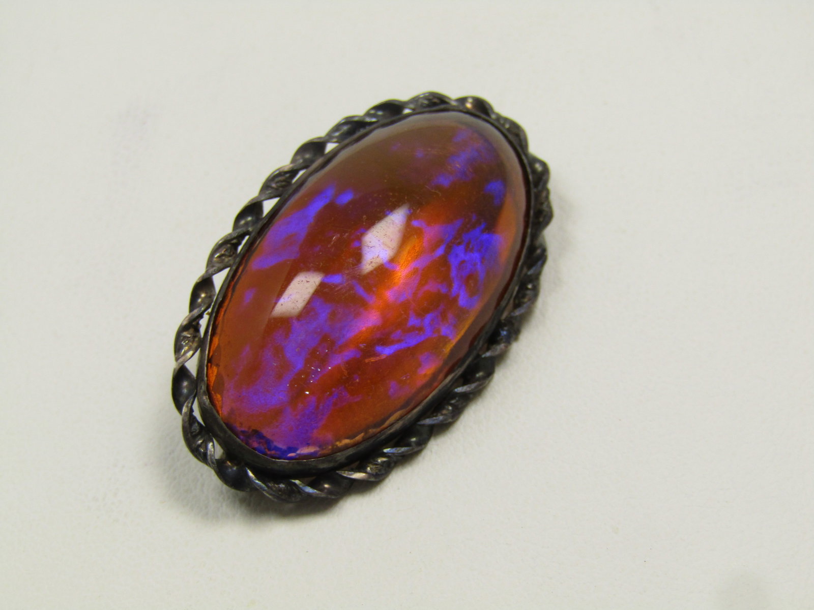 Vintage Sterling Dragon's Breath Brooch, 1940's-1950's: Vintage Sterling Dragon's Breath Brooch, 1940's-1950's. This is marked sterling and tests as sterling and the total weight of the brooch is appx. 10.45grams. It has a bezel setting with twisted sterli