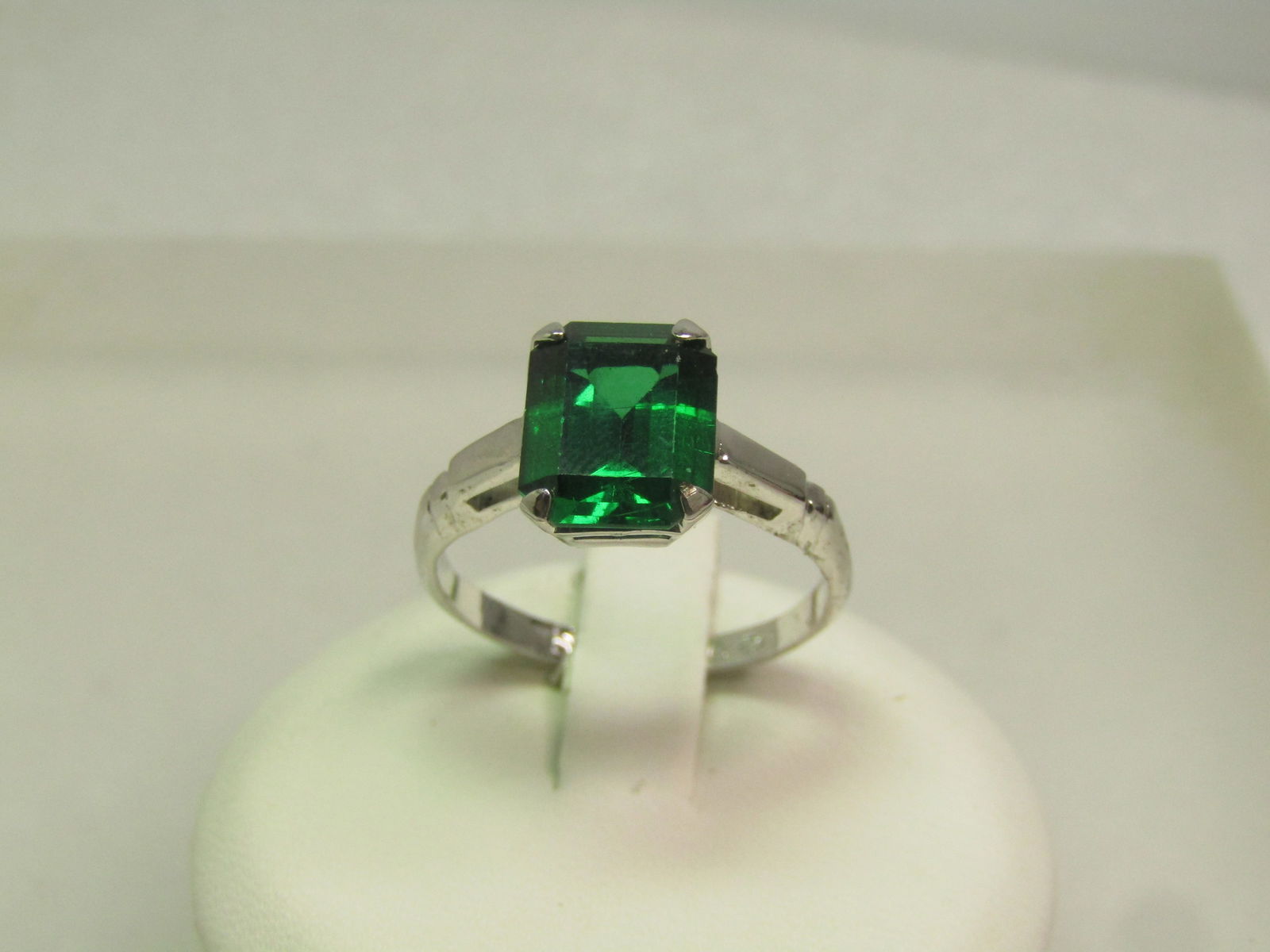 Vintage Green Rectangular Cut Stone Ring, Marked Sterling, Sz. 7.5, 1960's-1970's, Signed: Vintage Green Rectangular Cut Stone Ring, Marked Sterling, Sz. 7.5, 1960's-1970's, Signed with a V overlapping a diamond outline. the stone does test as spinel on a Presidium - likely would be a lab c