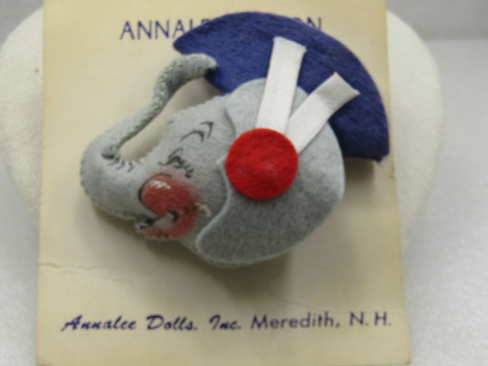 Felt Elephant Brooch Annalee Pin-On, Vintage New on Card, Mint: Felt Elephant Brooch Annalee Pin-On, Vintage New on Card, Mint. 1930's-1940's. This is gray felt with painted facial features and red white, and blue cap by Annalee Dolls, Inc., Meredith, NH. It is ap