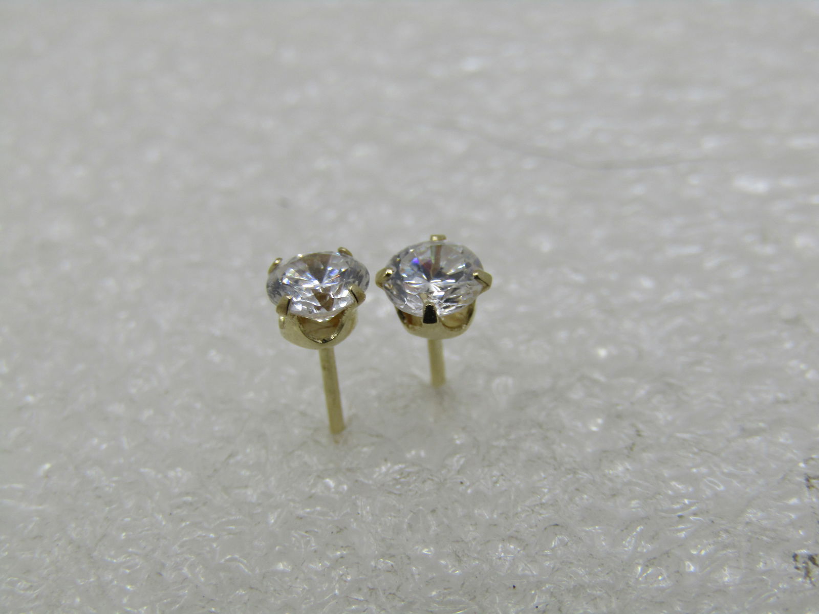 Vintage 14kt CZ Stud Earring, Signed AZ: Vintage 14kt CZ Stud Earring, Signed A&Z. The studs are round CZs that are appx. 3.5mm and prong set. The post is marked 14kt and signed A&Z. Age is post mid-century. The clutches are not gold, just t